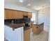 Well-equipped kitchen with granite countertops, wood cabinets, and modern appliances at 7419 S 45Th Ave, Laveen, AZ 85339