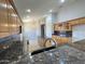 Modern kitchen with granite counters, wood cabinets, an island, and stainless steel appliances at 7419 S 45Th Ave, Laveen, AZ 85339