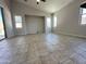 Bright living room with tile flooring, neutral colors, and a vaulted ceiling at 7419 S 45Th Ave, Laveen, AZ 85339