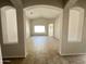 Open-concept living room with tile flooring, vaulted ceilings, and archways for easy flow at 7419 S 45Th Ave, Laveen, AZ 85339