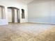Large, open living area showcases neutral paint and tile flooring, ready for personalization at 7419 S 45Th Ave, Laveen, AZ 85339