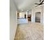 Open-concept living space with tile flooring, neutral colors, and seamless flow to kitchen at 7419 S 45Th Ave, Laveen, AZ 85339