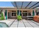 Backyard patio area featuring a covered structure, outdoor furniture, and lush landscaping at 758 S Lagoon Dr, Gilbert, AZ 85233