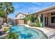 Beautiful swimming pool with rock waterfall feature and tropical landscaping at 758 S Lagoon Dr, Gilbert, AZ 85233