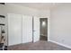Neutral bedroom featuring a carpet floor, a closet with sliding doors, and an adjacent doorway at 758 S Lagoon Dr, Gilbert, AZ 85233