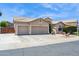Spacious driveway leads to a three-car garage on this well-kept home under a sunny sky at 758 S Lagoon Dr, Gilbert, AZ 85233