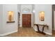 Elegant foyer featuring double doors, tile flooring, art niches, and console table at 758 S Lagoon Dr, Gilbert, AZ 85233