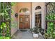 Inviting double front doors framed by lush greenery create a warm entrance to this home at 758 S Lagoon Dr, Gilbert, AZ 85233