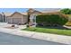 Lush green lawn and manicured bushes accent this home's beautiful desert landscaping at 758 S Lagoon Dr, Gilbert, AZ 85233