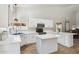 Bright, all-white kitchen featuring white marble countertops, stainless steel appliances and a central island at 758 S Lagoon Dr, Gilbert, AZ 85233