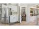 Kitchen with stainless steel refrigerator, white cabinets, and a doorway view into the living area at 758 S Lagoon Dr, Gilbert, AZ 85233