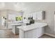 Bright, all-white kitchen featuring white marble countertops, stainless steel appliances and a central island at 758 S Lagoon Dr, Gilbert, AZ 85233