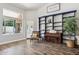 Charming living space with hardwood floors, large window, bookcase and upright piano at 758 S Lagoon Dr, Gilbert, AZ 85233