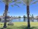 Scenic waterfront view with palm trees, a bench, and stunning waterfront homes in the background at 758 S Lagoon Dr, Gilbert, AZ 85233