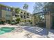 Scenic courtyard view with a small pond, grill, outdoor dining area, and lush landscaping at 7601 E Indian Bend Rd # 1040, Scottsdale, AZ 85250