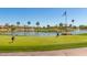 View of lush golf course with lake, palm trees, and fountain feature, perfect for golf enthusiasts at 7601 E Indian Bend Rd # 1040, Scottsdale, AZ 85250