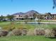 Scenic golf course view with lush green grass, a tranquil pond, and distant mountain backdrop at 7601 E Indian Bend Rd # 1040, Scottsdale, AZ 85250