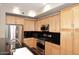 Well-lit kitchen boasts stainless appliances, light cabinetry and dark granite countertops at 7601 E Indian Bend Rd # 1040, Scottsdale, AZ 85250