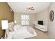 Serene bedroom with neutral tones, a ceiling fan, and plantation shutters at 7601 E Indian Bend Rd # 1040, Scottsdale, AZ 85250