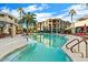 Beautiful community pool with crystal clear water and poolside seating surrounded by lush landscaping at 7601 E Indian Bend Rd # 1040, Scottsdale, AZ 85250