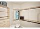 Bright walk-in closet features custom shelving, hanging rods, and two ottomans for added convenience at 7601 E Indian Bend Rd # 1040, Scottsdale, AZ 85250
