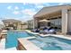 Beautiful backyard showcasing a pool, spa, covered patio, outdoor kitchen, and desert landscaping at 8396 E Granite Pass Rd, Scottsdale, AZ 85266