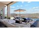 Luxurious backyard retreat featuring a covered patio, outdoor lounge, pool, and mountain views at 8396 E Granite Pass Rd, Scottsdale, AZ 85266