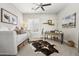 Bedroom with a daybed, a workspace, and a decorative cowhide rug at 8396 E Granite Pass Rd, Scottsdale, AZ 85266