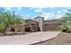 Beautiful stucco home with a stone facade, well-maintained landscaping, and a paver driveway at 8396 E Granite Pass Rd, Scottsdale, AZ 85266