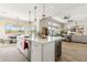 Bright kitchen features a large island with quartz countertops and a wine fridge at 8396 E Granite Pass Rd, Scottsdale, AZ 85266