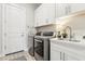 Laundry room with front loading washer and dryer, sink, and cabinet storage at 8396 E Granite Pass Rd, Scottsdale, AZ 85266