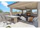 Inviting outdoor kitchen with fireplace, bar, and grill perfect for enjoying the beautiful weather and hosting gatherings at 8396 E Granite Pass Rd, Scottsdale, AZ 85266