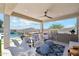 Inviting covered outdoor living space with a full kitchen, fireplace, seating, and a view of the pool at 8396 E Granite Pass Rd, Scottsdale, AZ 85266