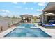 Stunning pool area with a spa, built-in barbecue, covered dining, and lounge chairs at 8396 E Granite Pass Rd, Scottsdale, AZ 85266