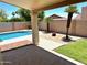 Inviting backyard featuring a sparkling pool, desert landscaping, and a covered patio at 9109 W Watson Ln, Peoria, AZ 85381