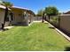 Expansive backyard with lush lawn, covered patio, and sparkling pool, creating a serene outdoor oasis at 9109 W Watson Ln, Peoria, AZ 85381