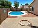 A large in-ground swimming pool and a circular fire pit feature in this well-maintained backyard oasis at 9109 W Watson Ln, Peoria, AZ 85381