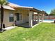 Backyard showcasing a covered patio, lush green lawn, and a refreshing pool, perfect for outdoor living at 9109 W Watson Ln, Peoria, AZ 85381