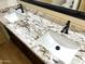 A bathroom featuring a double sink vanity with granite countertops and black hardware at 9109 W Watson Ln, Peoria, AZ 85381