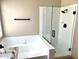 A luxurious bathroom features a separate tub and shower with white tiles at 9109 W Watson Ln, Peoria, AZ 85381