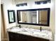 A spacious bathroom features a large mirror and a double sink vanity with granite countertops at 9109 W Watson Ln, Peoria, AZ 85381