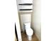 A compact bathroom features a toilet and built-in shelves at 9109 W Watson Ln, Peoria, AZ 85381
