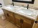 Modern bathroom vanity with double sinks, granite countertop, and contemporary black fixtures at 9109 W Watson Ln, Peoria, AZ 85381