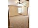 A spacious bedroom with neutral carpet and trim, a ceiling fan, and natural light at 9109 W Watson Ln, Peoria, AZ 85381