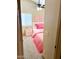 A bright, pink bedroom featuring carpet floors, a large window, and a comfortable twin bed at 9109 W Watson Ln, Peoria, AZ 85381