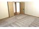 A spacious bedroom with neutral carpet and trim that leads to an adjoining bedroom at 9109 W Watson Ln, Peoria, AZ 85381
