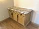 Three cabinets in a hallway nook with granite countertops at 9109 W Watson Ln, Peoria, AZ 85381