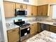 The kitchen includes stainless steel appliances, granite countertops, and stylish cabinets at 9109 W Watson Ln, Peoria, AZ 85381
