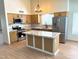 Stylish kitchen with stainless appliances, granite countertops, an island with seating, and natural light from large windows at 9109 W Watson Ln, Peoria, AZ 85381