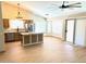 Bright kitchen features wood-look flooring, stainless steel appliances, granite counters and a large island for extra seating at 9109 W Watson Ln, Peoria, AZ 85381